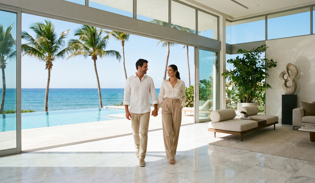 Professional couple touring a Dorado Beach Resort villa — Act 60 tenants Puerto Rico