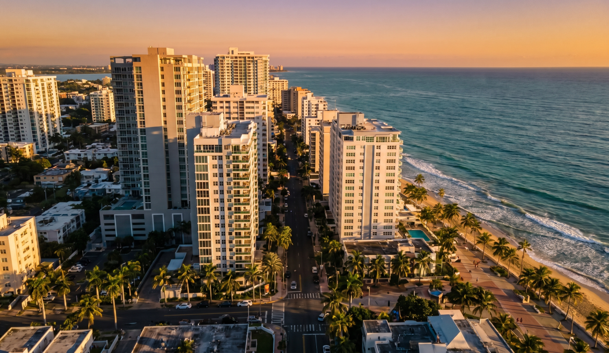 Aerial view of Condado San Juan luxury condos at golden hour — Puerto Rico rental market 2026